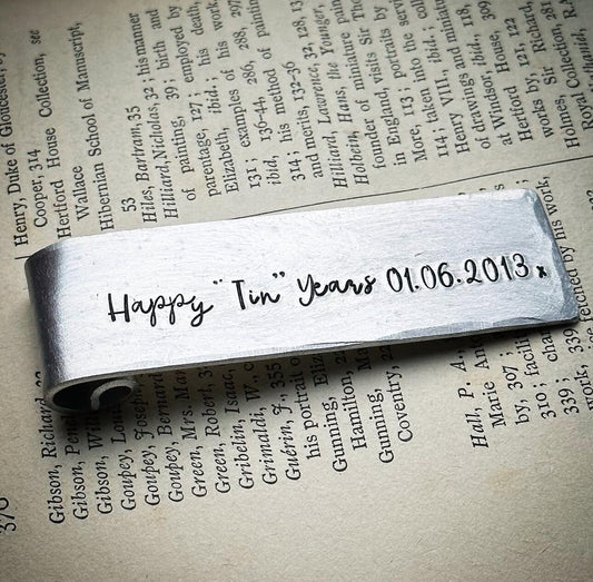 A silver aluminum bookmark GIFT with the CUSTOM inscription 'Happy Tin Years 01.06.2013' printed on it.