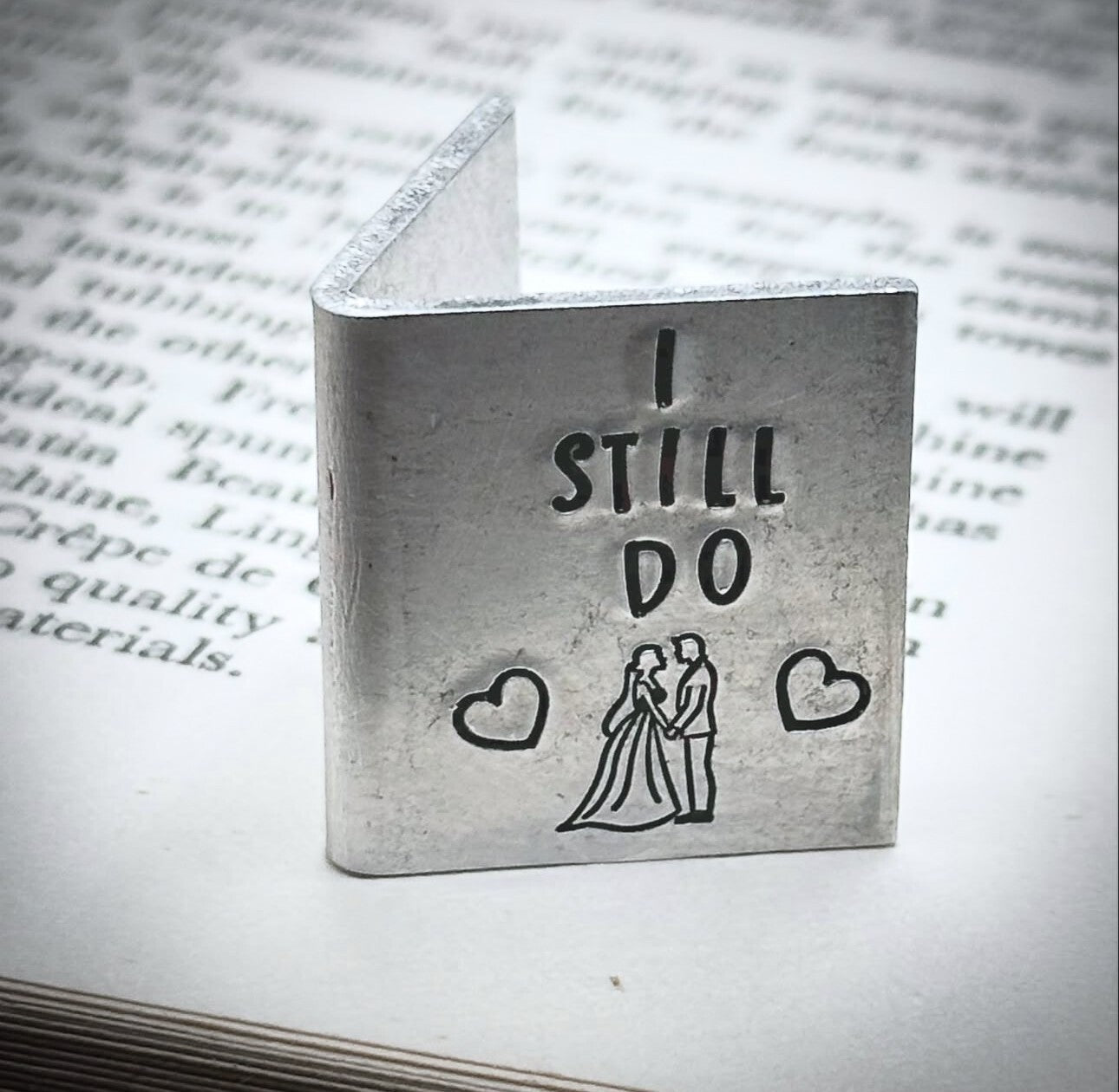 A silver wedding anniversary card with the inscription 'I STILL DO' along with a heart and a silhouette of a couple.
