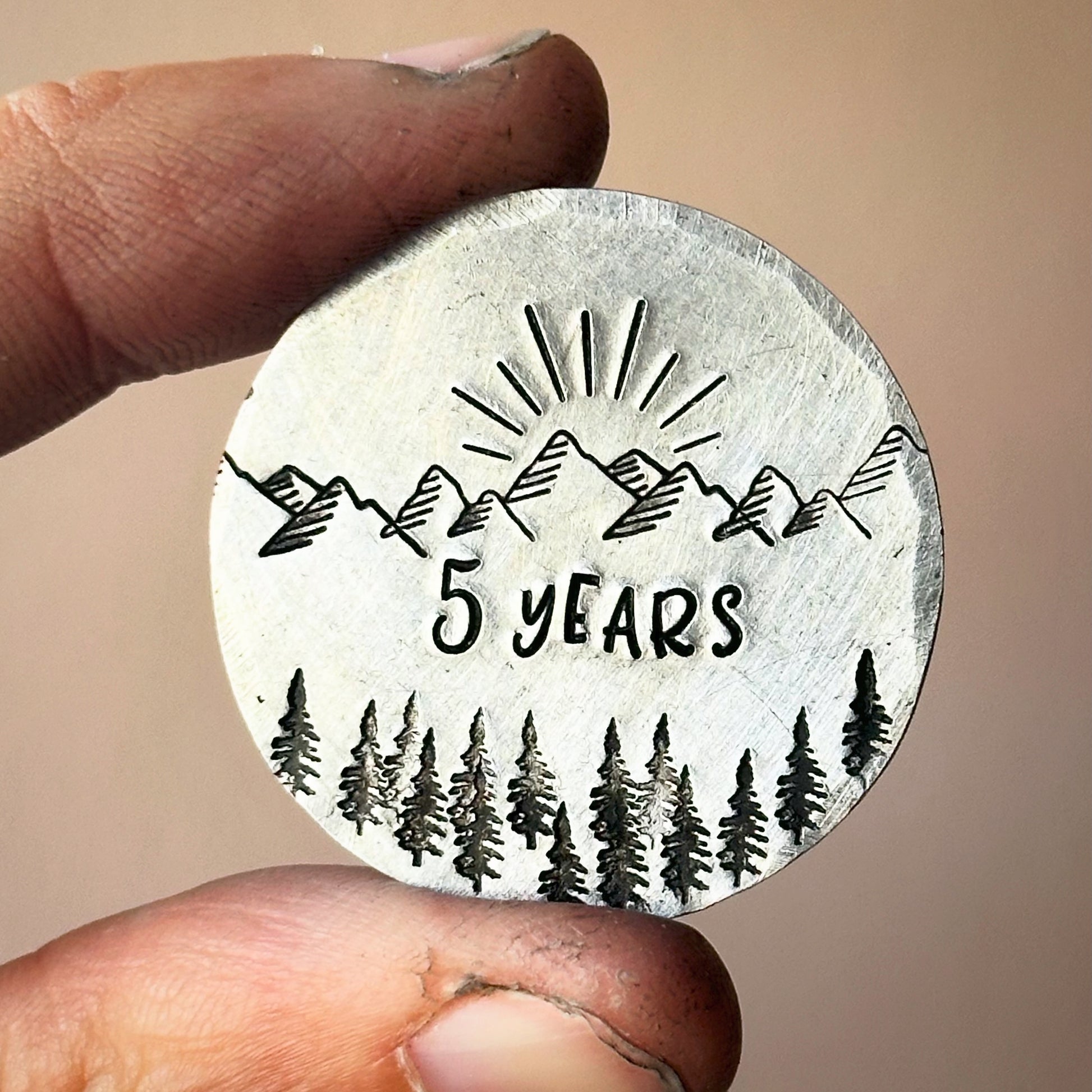 A silver personalized sobriety gift coin