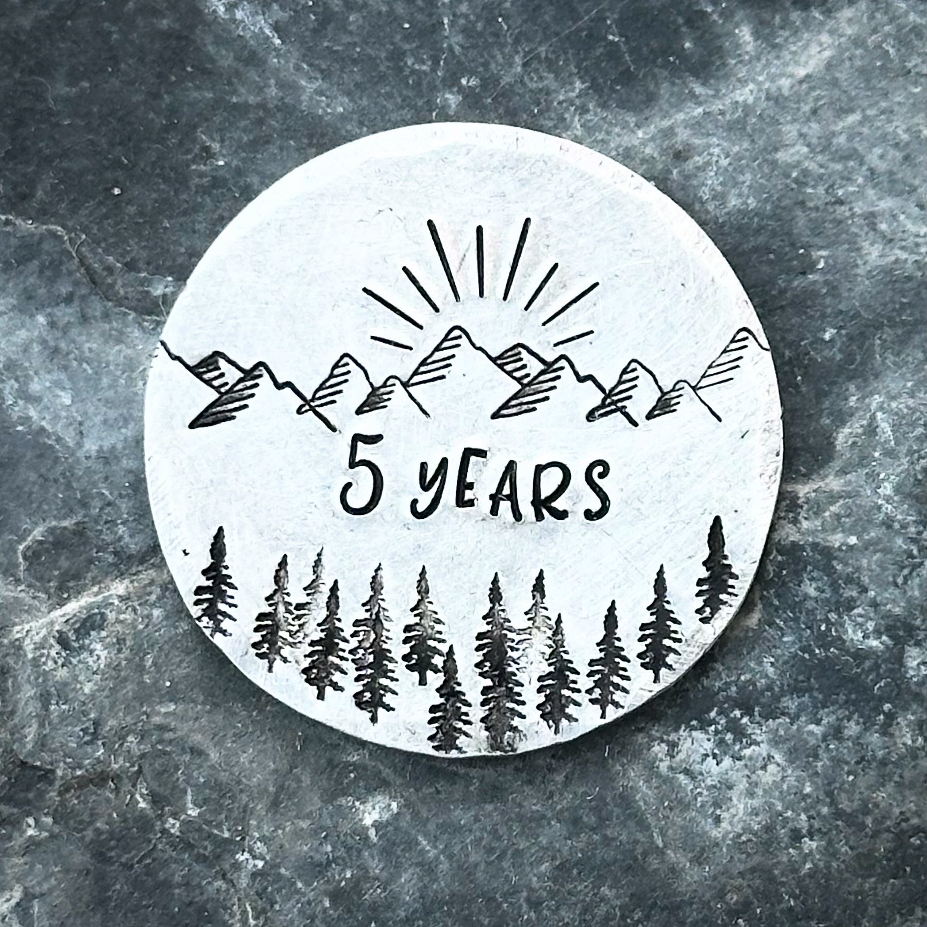 A silver personalized sobriety gift coin