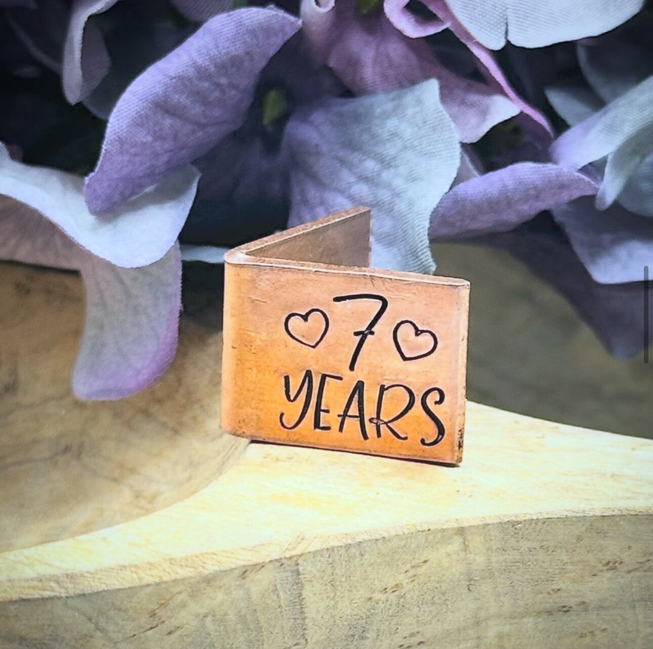 A personalized copper 7th wedding anniversary card with '7 YEARS' engraved.