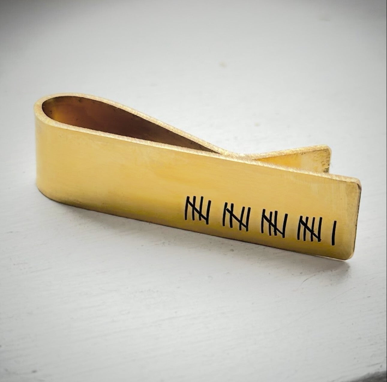 Gold metal clip with engravings